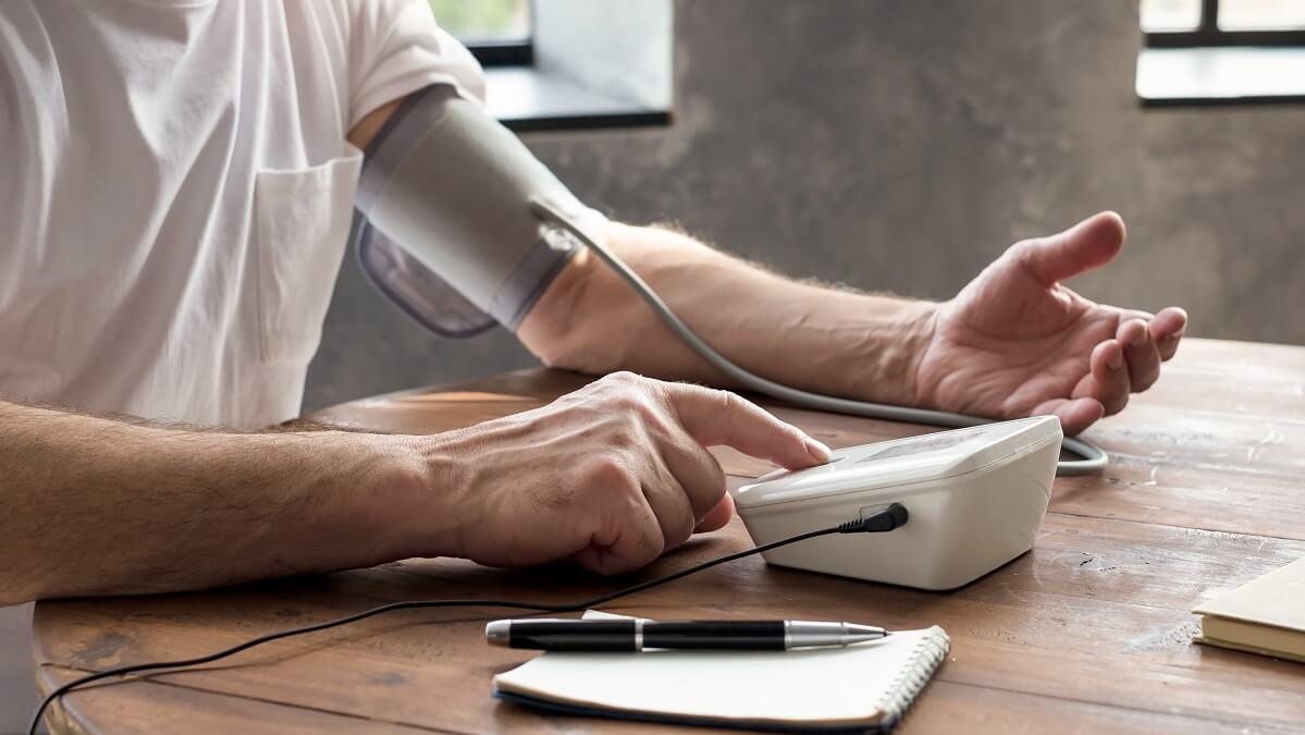 man taking his blood pressure reading