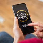 man looking at cashback apps on phone