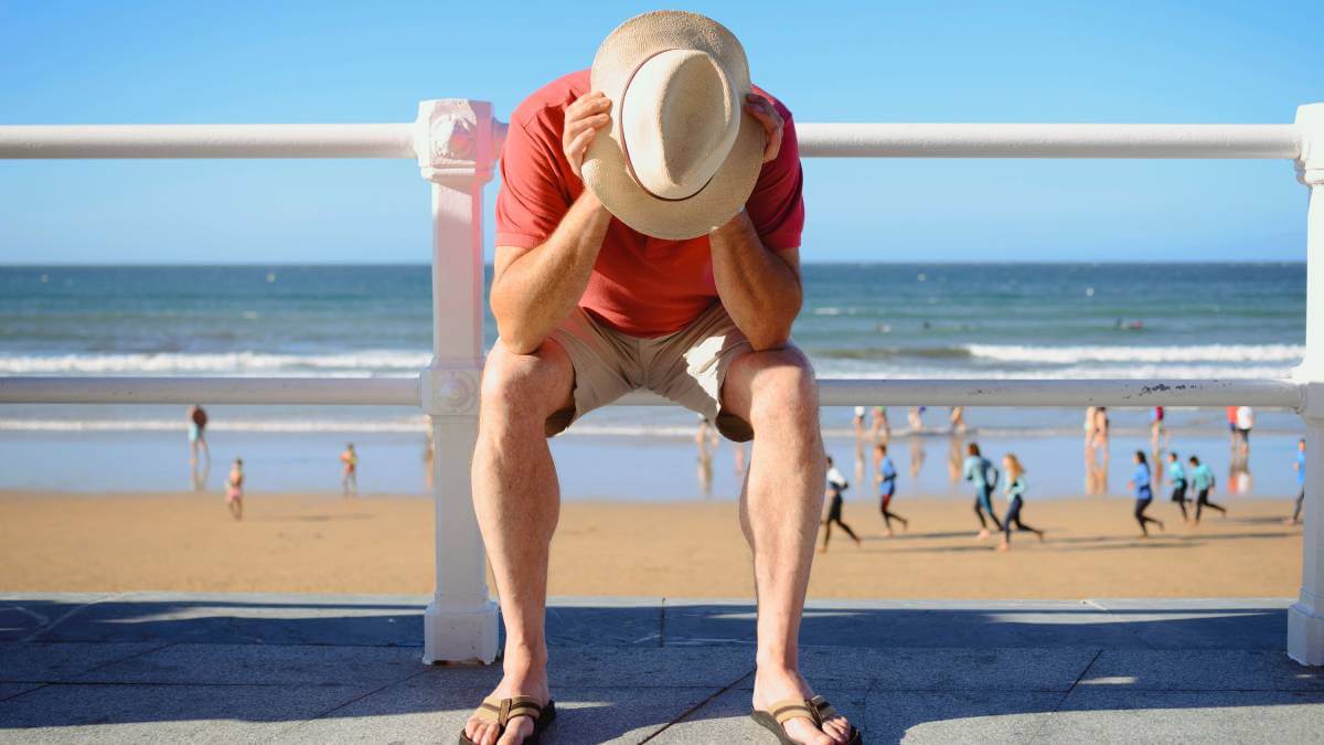 Man looking disappointed at the beach