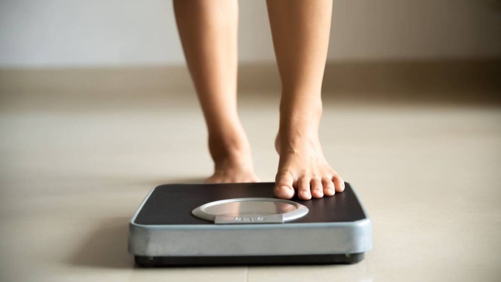 Women stepping on scale