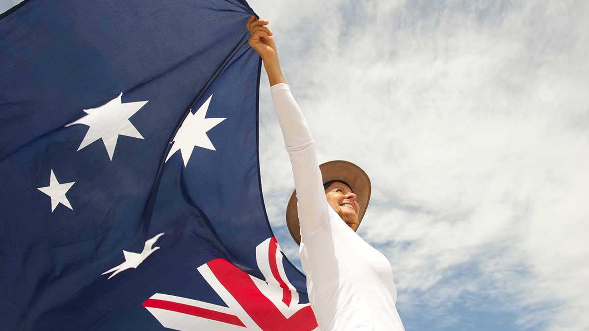 woman wearing akubra hat and with Australian flag around shoulder