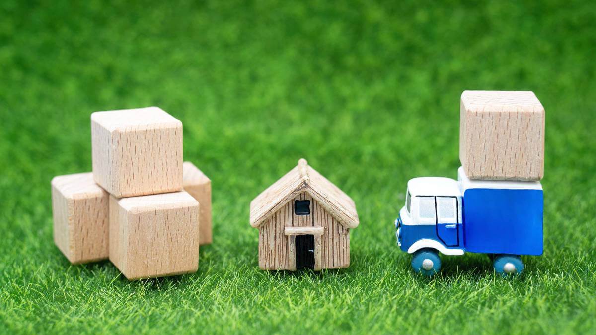 Small wooden house next to a toy car