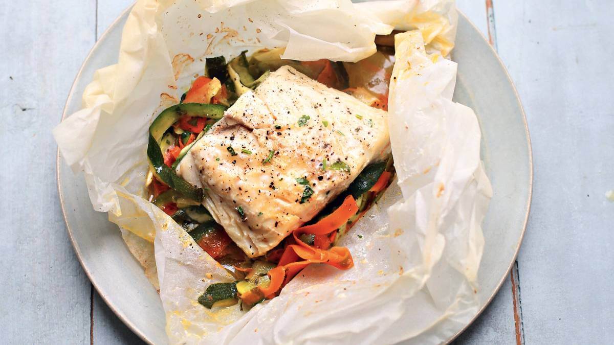 Baked white fish on a bed of vegetables
