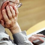 older man struggling with technology