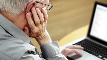 older man struggling with technology