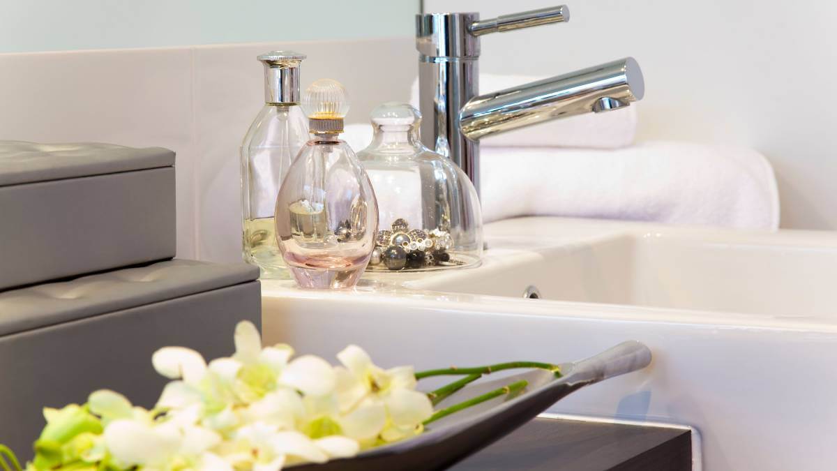 Perfume bottles standing next to a bathroom sink