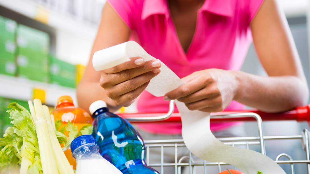 Woman checks her grocery receipt