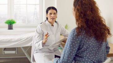 woman getting health check from gp