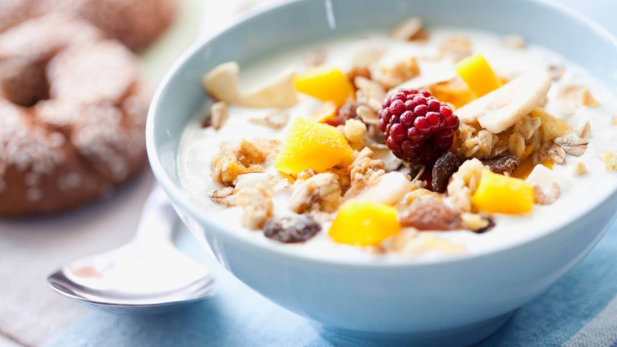 Bowl of porridge topped with fruit and nuts
