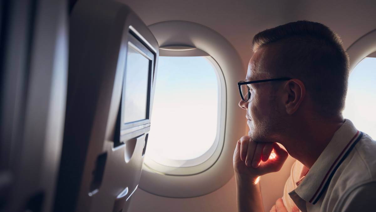 Man looking out a plane window