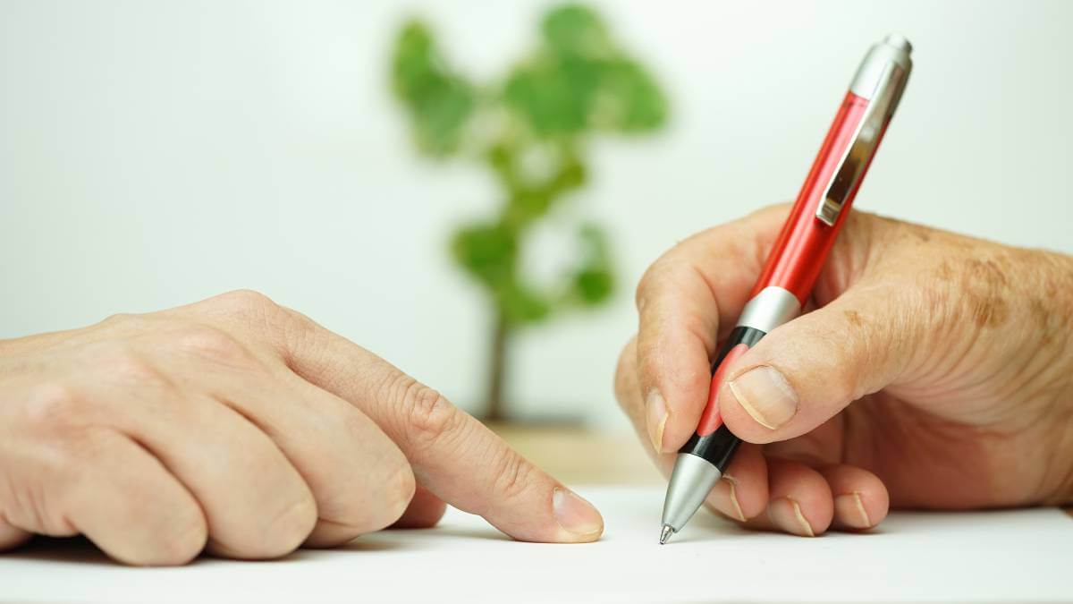 Older person signing documents
