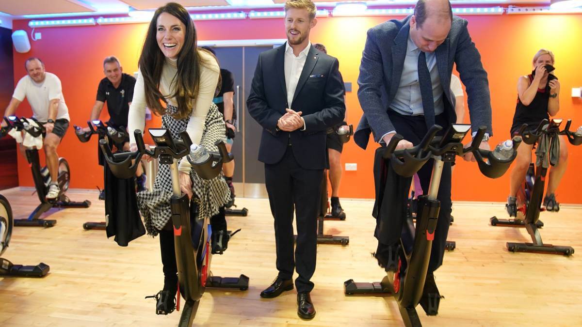 Kate and Will cycling on indoor bikes
