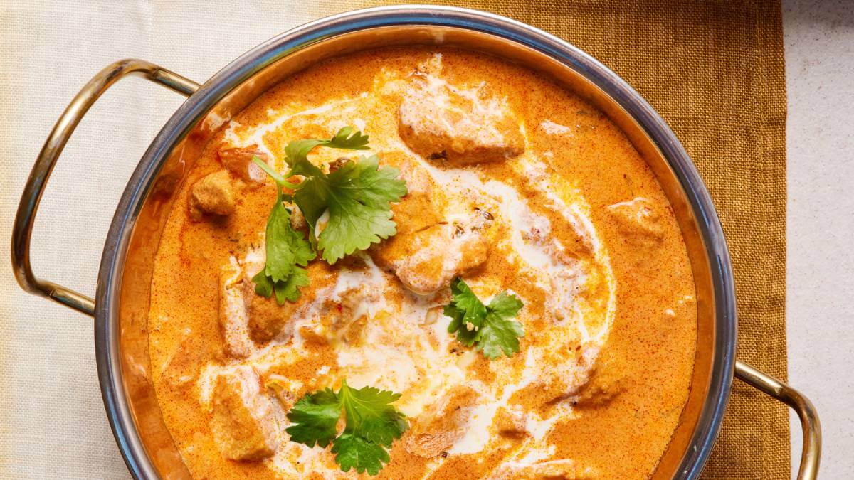 Butter chicken in a metal dish