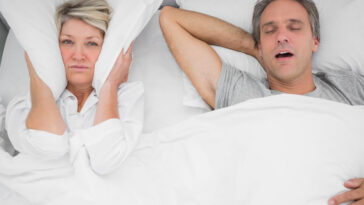 woman awake while husband snores