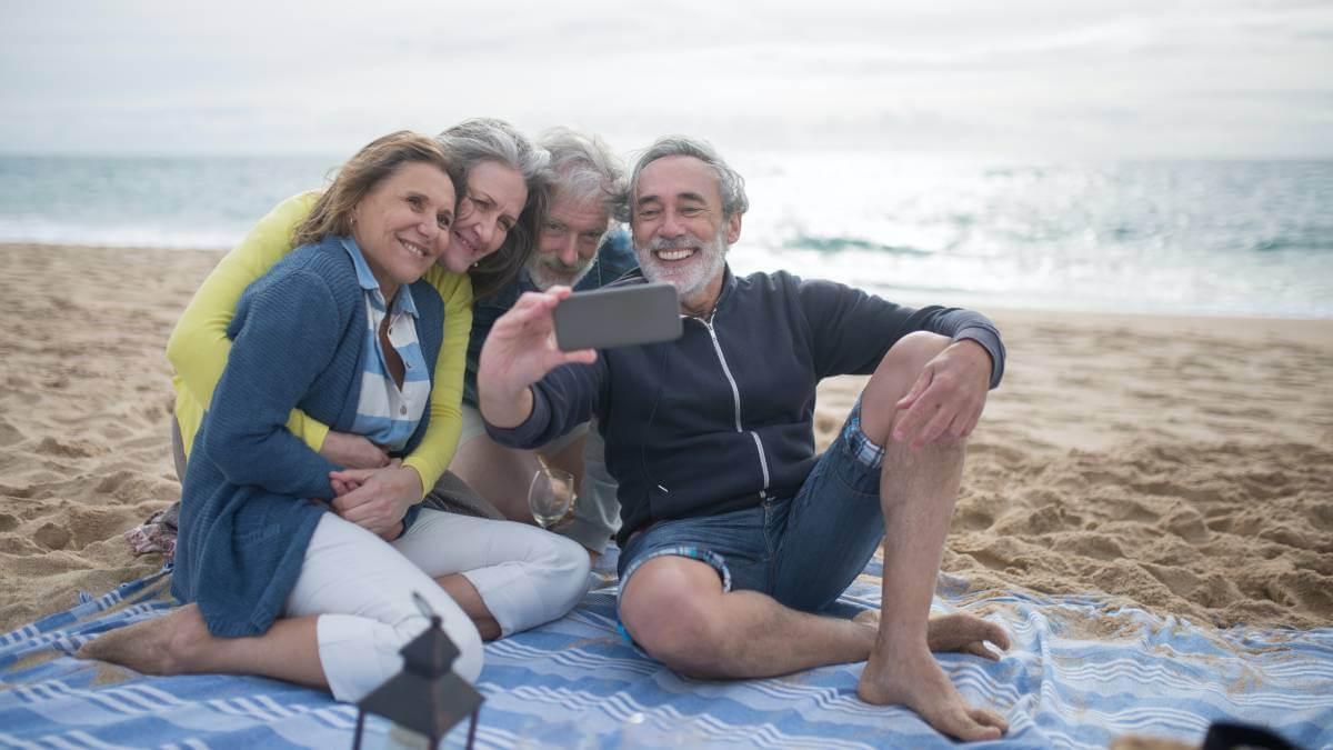 Four friends taking a photo on a beach