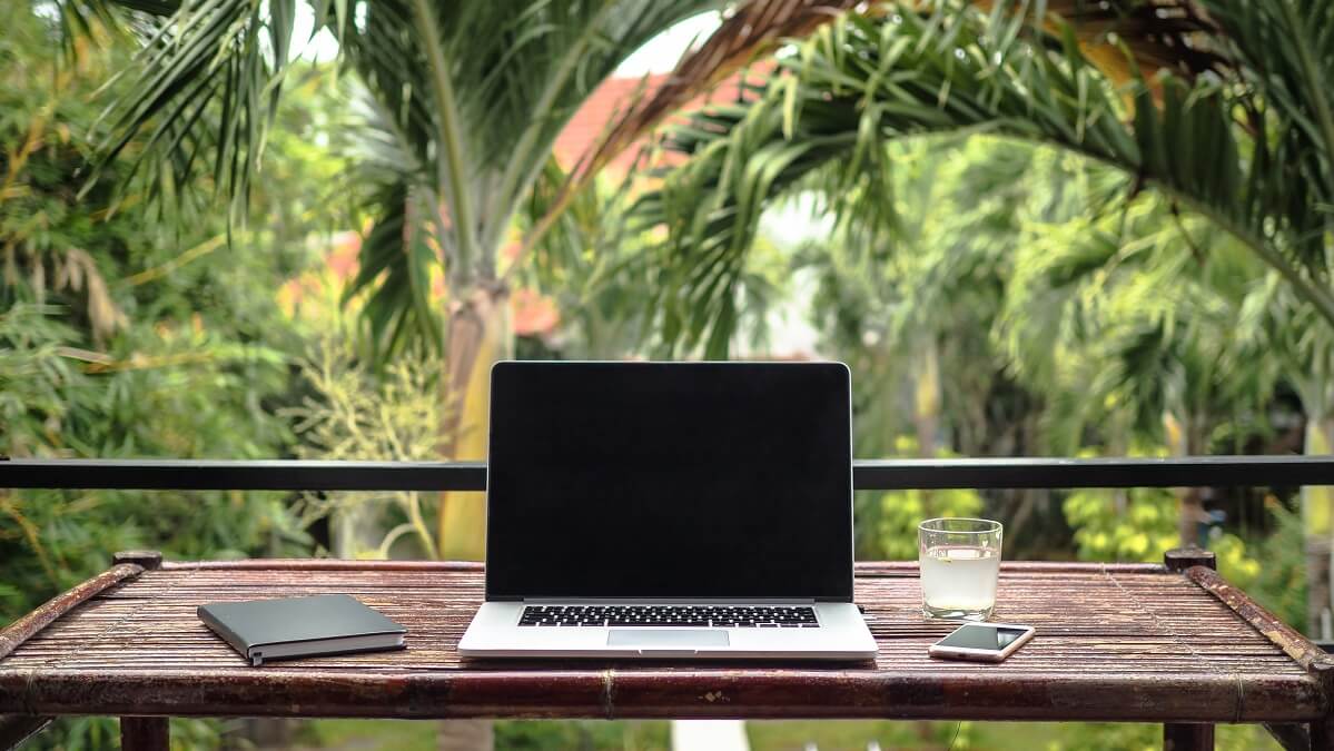 laptop on outdoor desk in paradise
