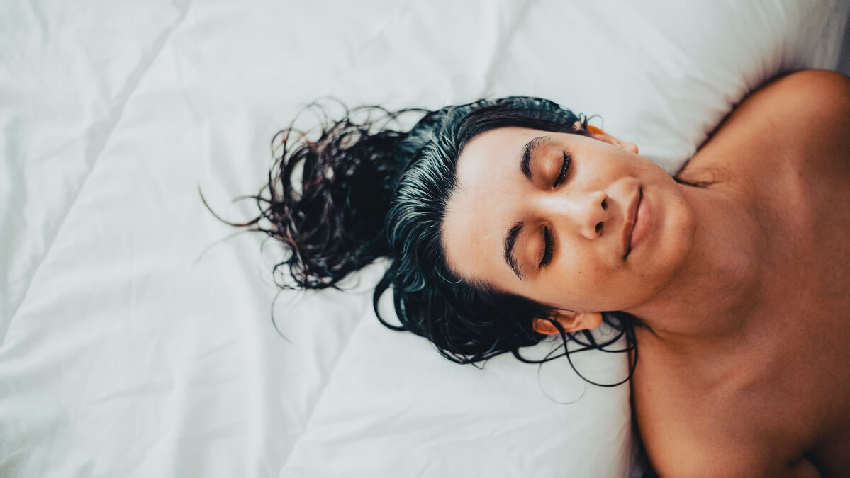 woman in bed with wet hair