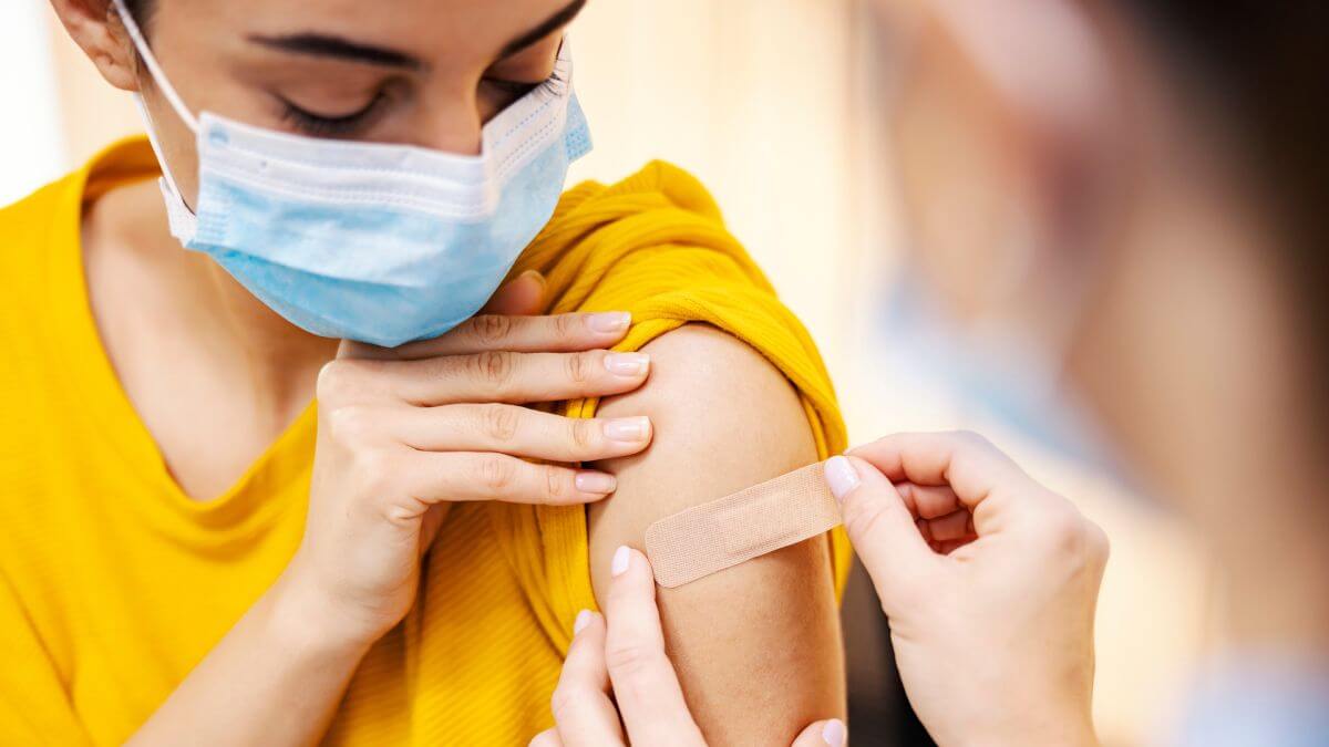 Woman putting a band aid after an injection