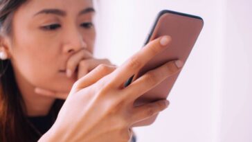 Woman looking sadly at her phone