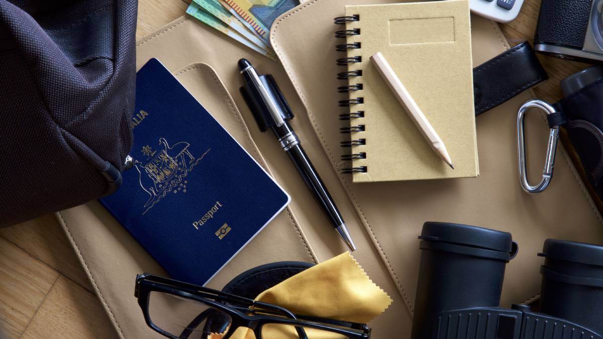 Australian passport next to a notebook and pencil