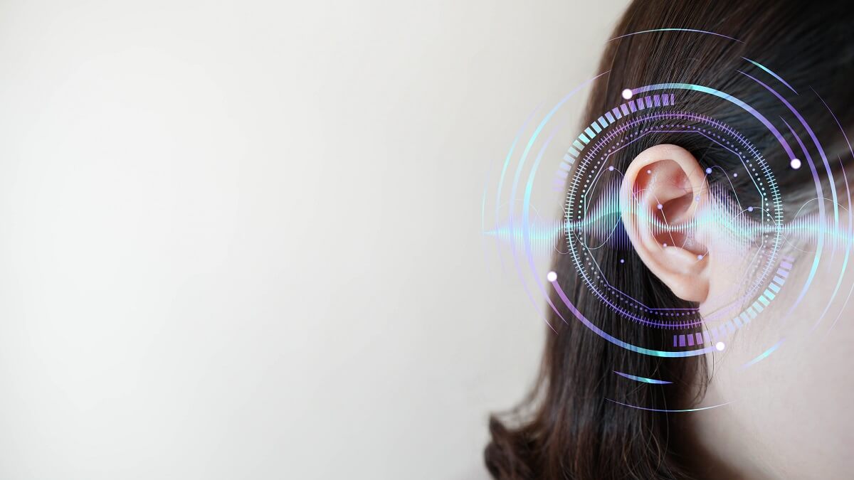 hearing aid in woman's ear