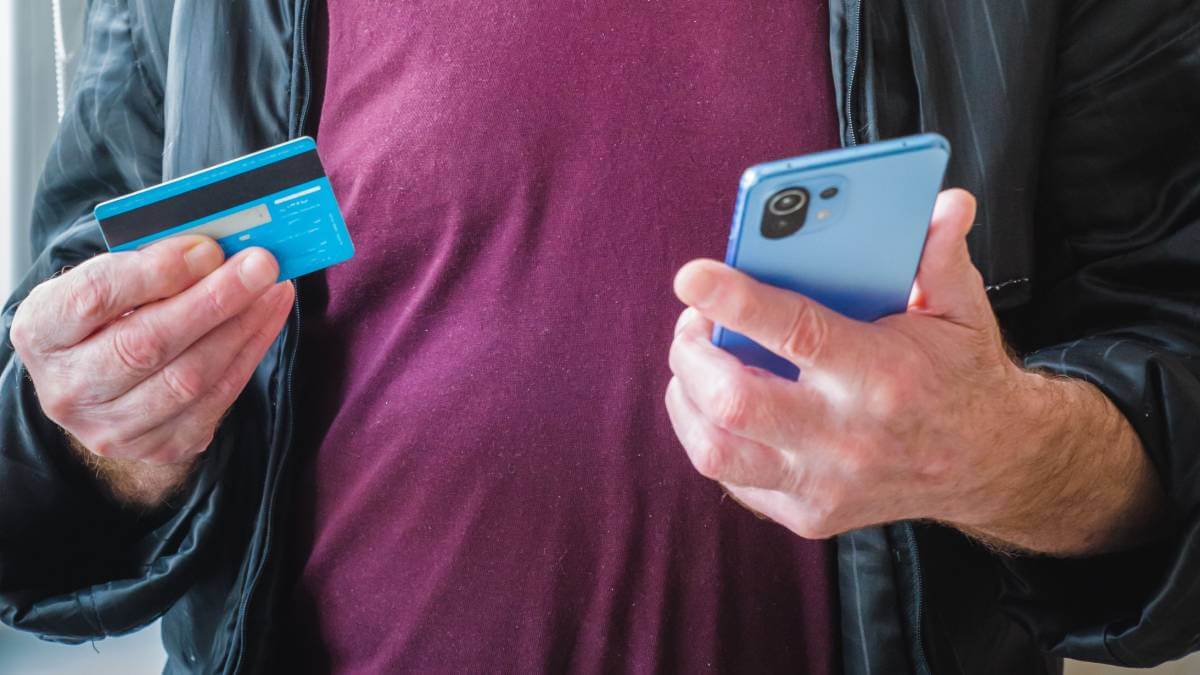 Man holding credit card and phone