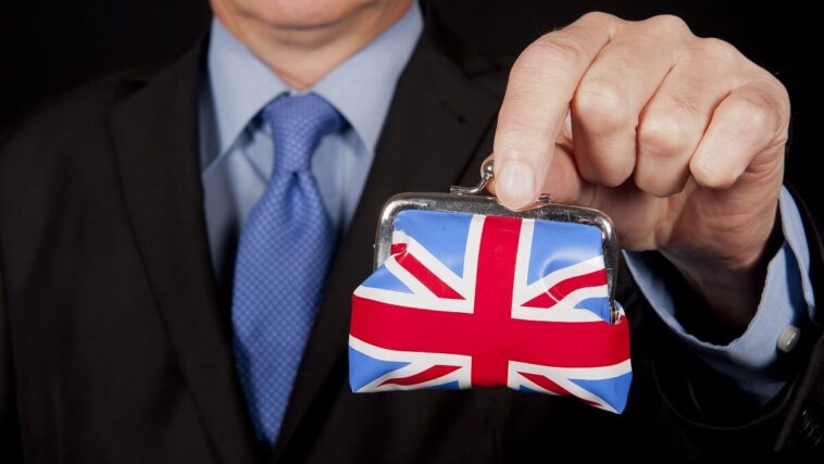 man holding coin purse decorated with union jack