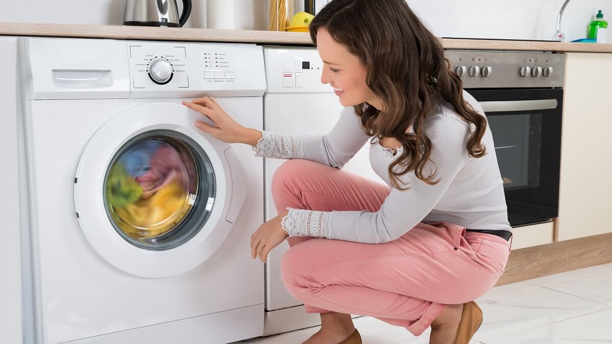 Woman using a tumble dryer