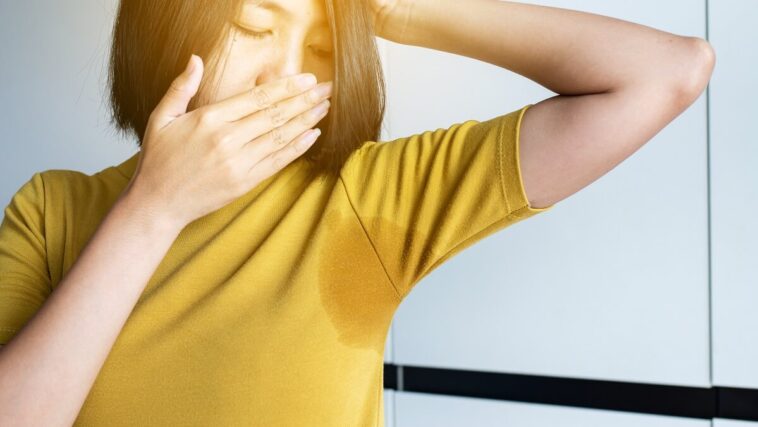 woman smelling her armpit