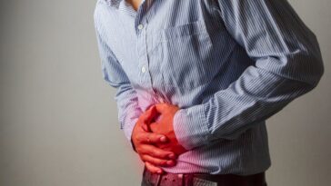 man struggling with gut health