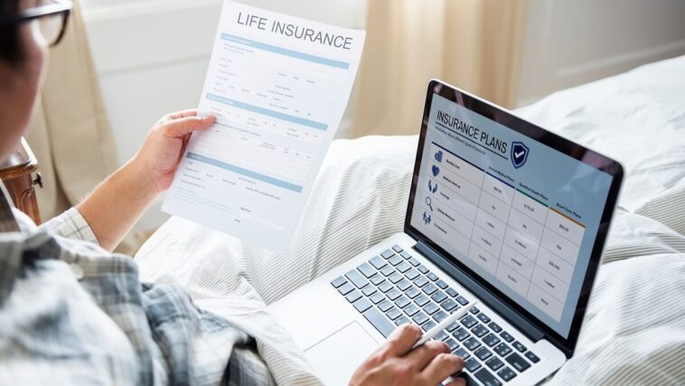 woman looking at life insurance documents