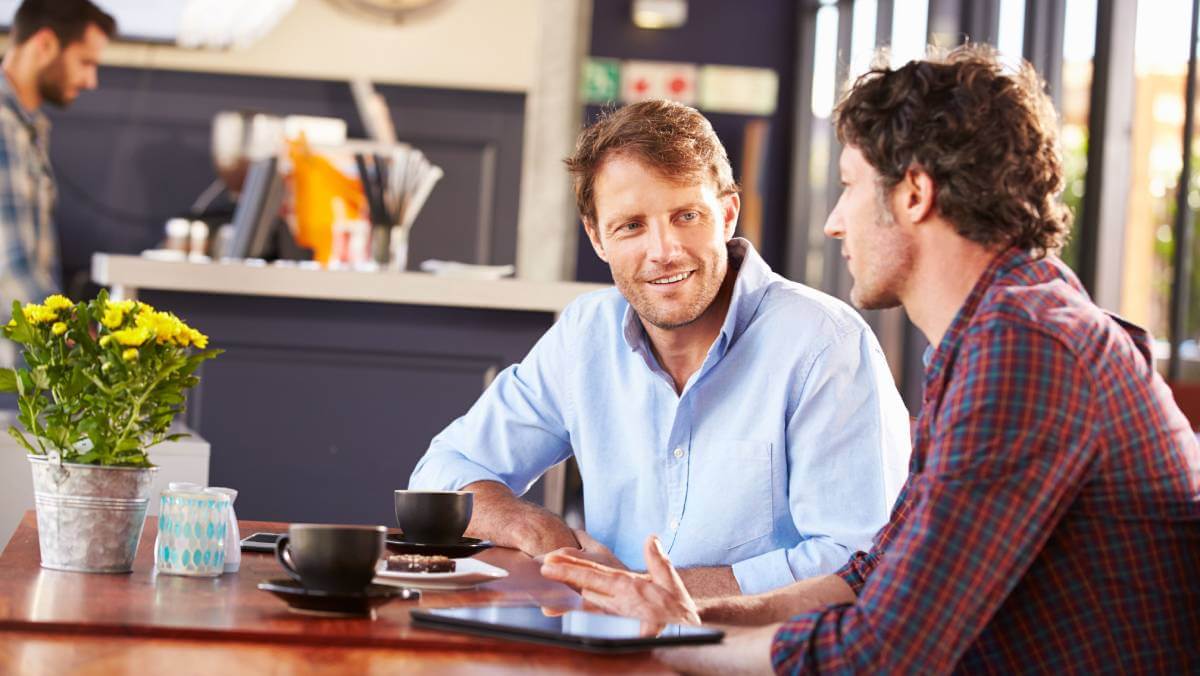 Two men talking in a coffee shop