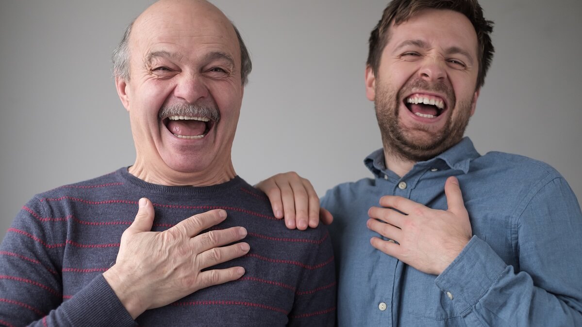 father and son laughing at joke