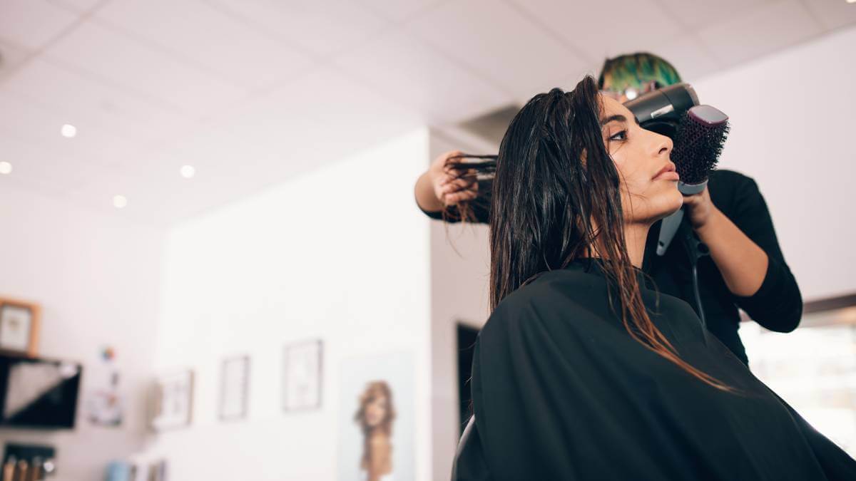 Woman getting her hair blowdried at a salon