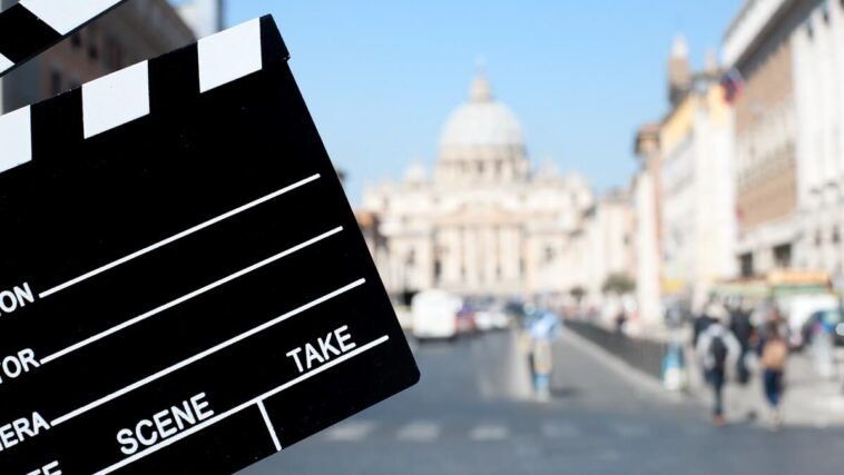 movie clapboard in front of st peters basilica