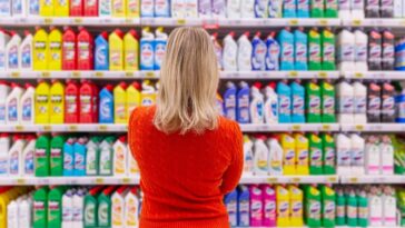 woman in cleaning product aisle at supermarket
