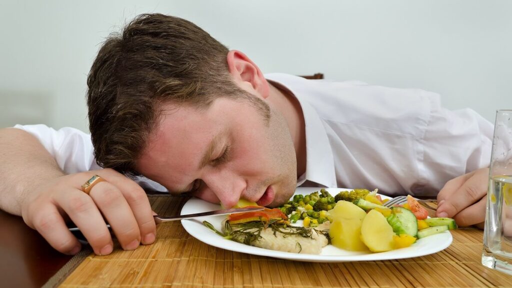 man sleeping in food