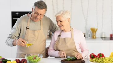 older couple cooking with olive oil