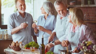group of baby boomers chatting in kitchen