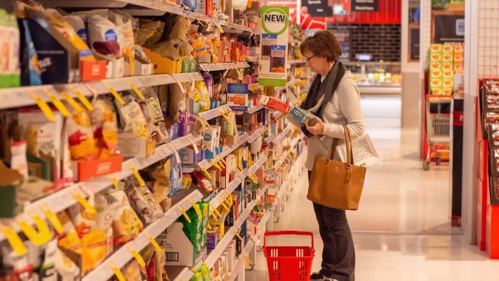 woman shopping in supermarket aisle