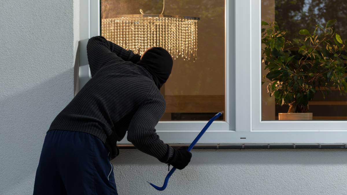 Burglar breaking into a house