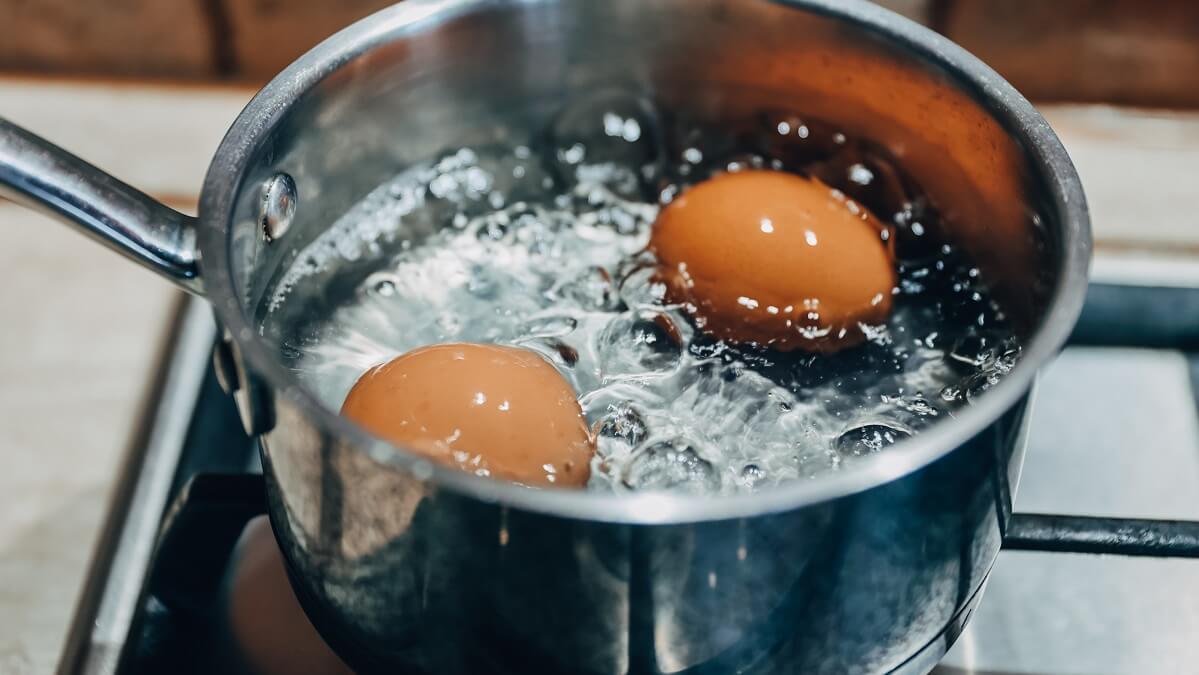 eggs boiling in pot on stove