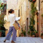 Stylish woman walking in Italy