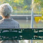 Older woman sad on a bench