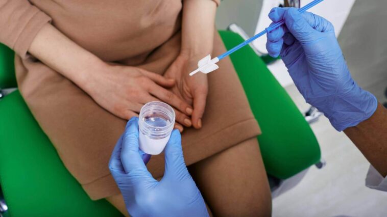 Doctor testing for cervical cancer