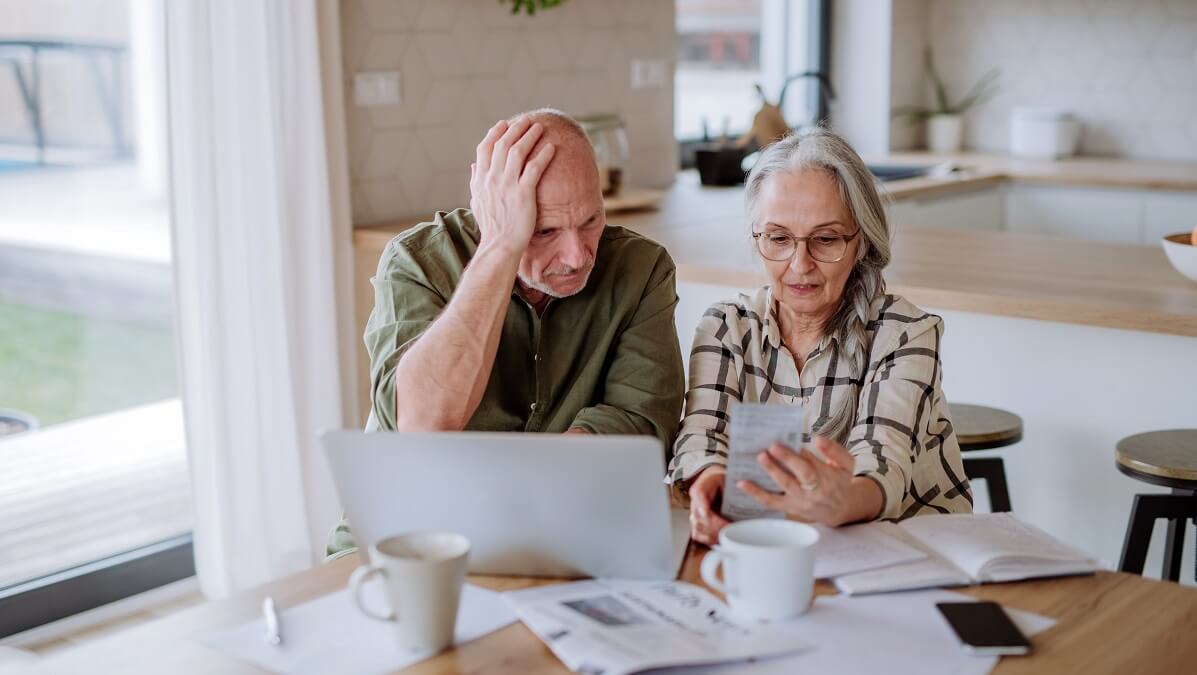 stressed older couple looking at finances