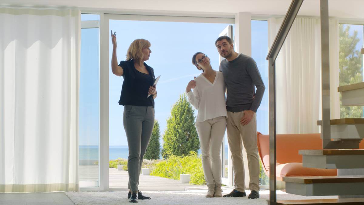 Real estate agent showing clients around