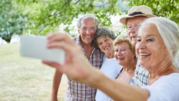 A group of retirees taking selfies