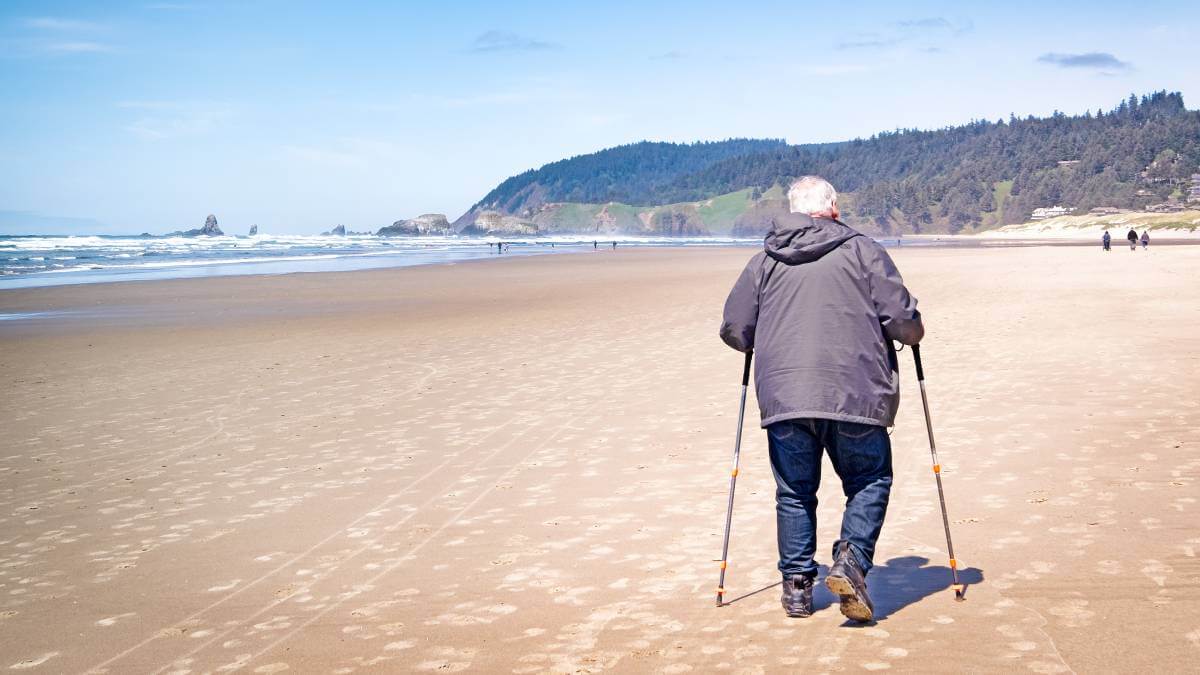Old man walking down the beach