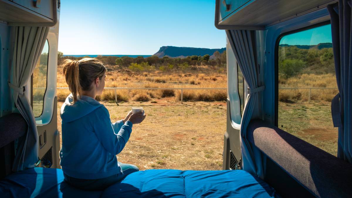 Woman overlooking the Australian outback from her caravan